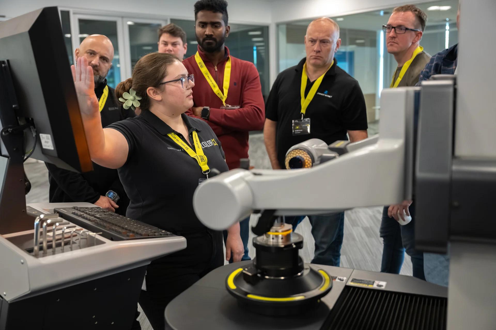 woman shows group of people a ZOLLER machine